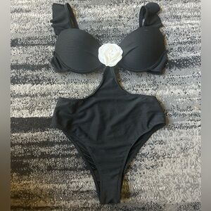 Black Ribbed One-Piece With Side Cut-Outs & White Flower Accent